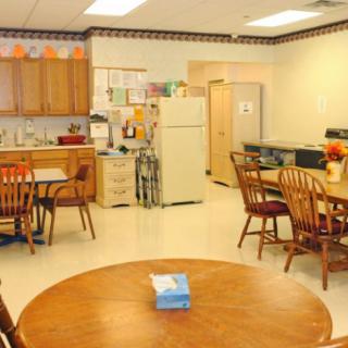 A cozy kitchen and dining area with wooden furniture and appliances.