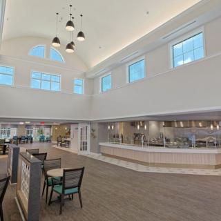 A spacious and modern cafe interior with ample natural light and a sleek design.