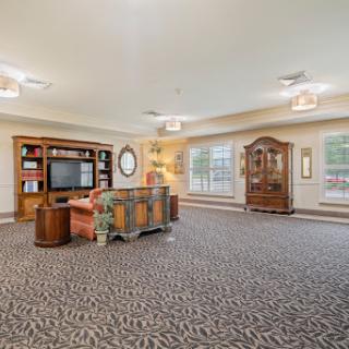 A spacious and inviting living room featuring elegant furniture and warm lighting.