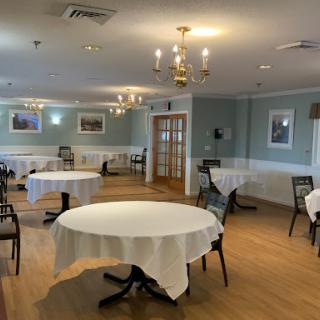 A serene dining area featuring elegantly arranged tables and ambient lighting.