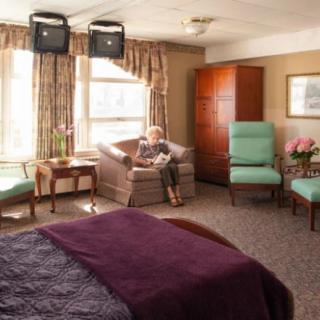 A cozy living space with comfortable furniture and a large window.