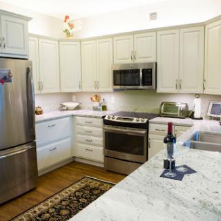 A modern kitchen featuring sleek appliances and a stylish marble countertop.