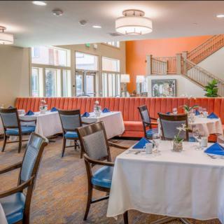 A modern and elegant restaurant dining area with neatly arranged tables and seating.