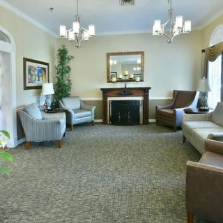 A cozy living room with comfortable seating, a fireplace, and elegant decor.
