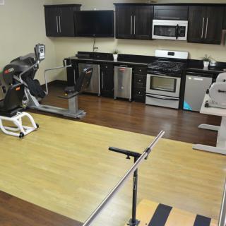 A home space combining kitchen and gym equipment for multi-purpose use.