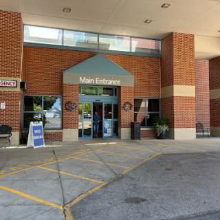 Main entrance of a commercial building with brick facade.