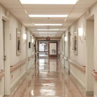 A clean and empty hospital corridor with bright lighting.