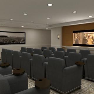 A small theater room with rows of comfortable seating facing a large screen.