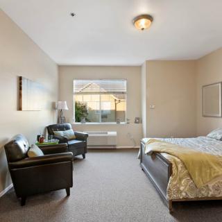A cozy bedroom with a comfortable bed and seating area.