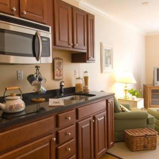 A cozy kitchen and living area with wood cabinets and modern amenities.