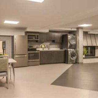 A modern open-plan kitchen with integrated laundry facilities.