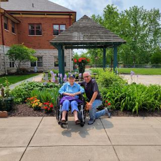 A joyful moment shared in the garden, celebrating companionship and support.