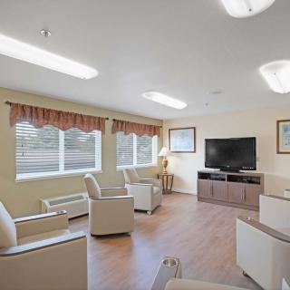A cozy living room with comfortable seating and a TV for entertainment.
