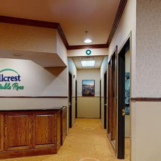 A hallway in an office setting with signage on the wall.