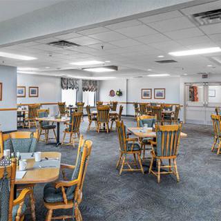 An empty dining area with neatly arranged tables and chairs.