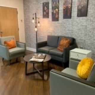 A cozy living room with modern furniture and warm decor.