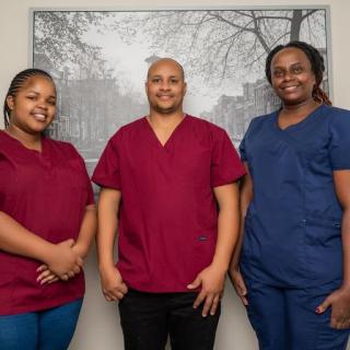 A group of medical professionals posing for a team portrait in their scrubs.