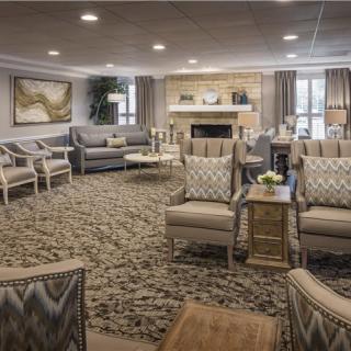A spacious and elegantly designed living room with comfortable seating and a warm fireplace.