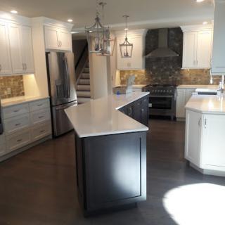 A beautifully designed modern kitchen showcasing an open layout with a central island and elegant cabinetry.