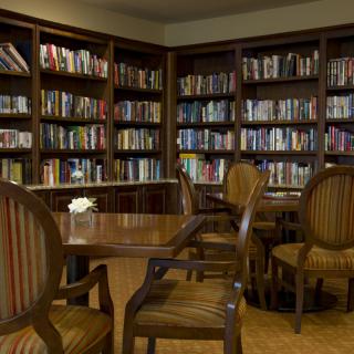 A cozy library corner with bookshelves and a seating area.