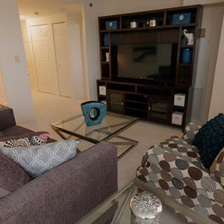 A cozy living room with a modern entertainment center and comfortable seating.