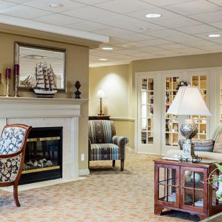A cozy living room with a fireplace and elegant furniture.