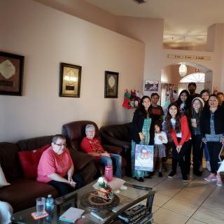 A group of people gathered in a living room for a casual gathering.
