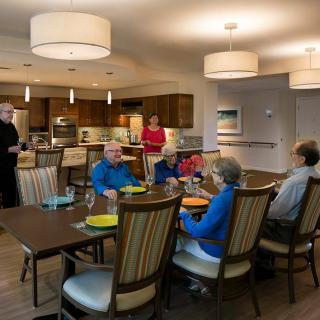 A group of people enjoying a meal together in a dining room setting.