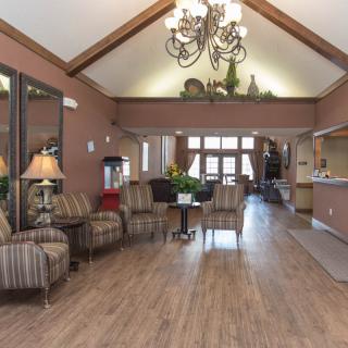 A cozy lobby with stylish furniture and a chandelier.