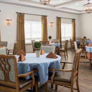 A beautifully arranged dining room featuring elegant furniture and warm lighting.