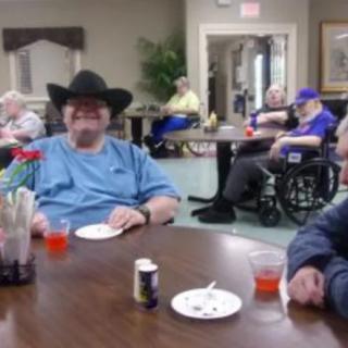 A group of seniors enjoying a gathering in a community room.
