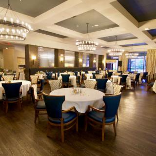 An elegant restaurant dining area with well-arranged tables and chandeliers.