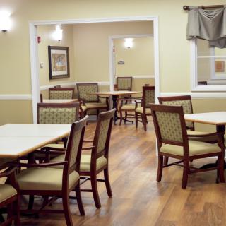A cozy dining area with several tables and chairs arranged neatly.