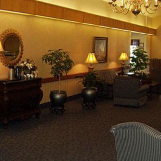 A cozy lobby area with elegant furniture and warm lighting.