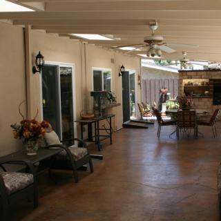 A spacious covered patio with comfortable seating and decor.
