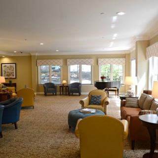A cozy living room with comfortable seating and large windows allowing natural light.