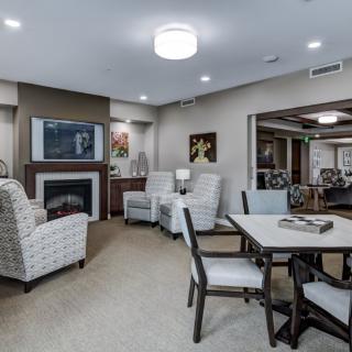 A cozy living room with comfortable seating, a fireplace, and a television.