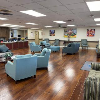 Spacious lounge area featuring comfortable blue seating and modern decor.