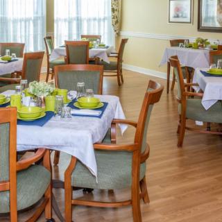 A well-decorated dining room with neatly arranged tables and chairs.
