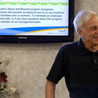 A man stands in front of a screen giving a presentation.