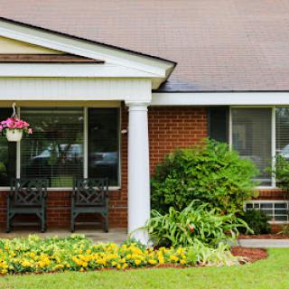 A charming house with a landscaped front yard and inviting porch.