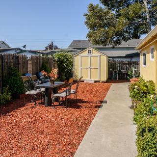 A well-maintained backyard with a shed, outdoor seating area, and landscaped garden.