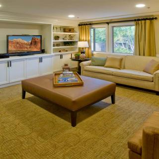 A cozy living room with a comfortable sofa, large coffee table, and television.