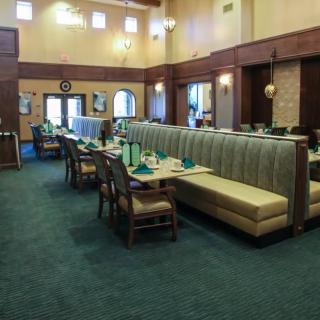 A spacious restaurant interior with neatly arranged tables and chairs.