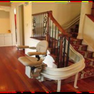 A home stairlift installed along a curved staircase.