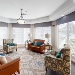 A cozy and bright living room with comfortable seating, large windows, and elegant decor.
