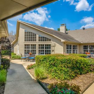 A beautiful house with a landscaped garden and clear blue sky.