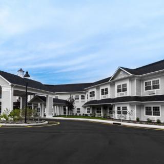 Exterior view of a large two-story residential building with a driveway.