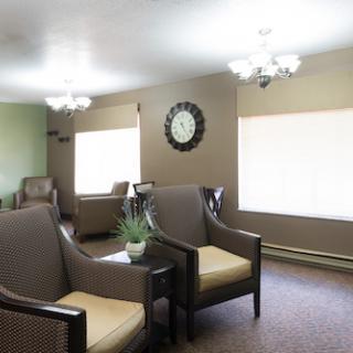 A cozy and well-lit living room space featuring comfortable chairs and modern decor.