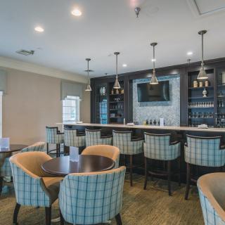 A modern bar and seating area with stylish interior design and cozy seating.